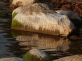 Beautiful rocks by the sea, colorful reflections in the water Royalty Free Stock Photo