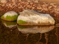 Beautiful rocks by the sea, colorful reflections in the water Royalty Free Stock Photo