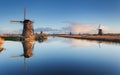 Landscape with beautiful traditional dutch windmills at sunrise Royalty Free Stock Photo