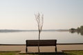 Landscape with bench on the lake shore Royalty Free Stock Photo