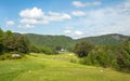 Landscape on Bjaavann golf course with green grass, trees, beautiful blue sky, panorama Royalty Free Stock Photo