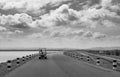 Landscape black and white Scenic road travel on empty highway and Electric Golf Cart near a large reservoir