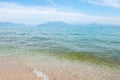 Landscape with blue sky, mountains and transparent blue turquoise water in lake Garda, Sirmione del Garda, Italy, Europe Royalty Free Stock Photo