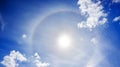 Landscape from the blue sky with sun, white clouds and halo Royalty Free Stock Photo