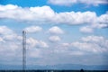 Landscape blue sky with white clouds group pattern floating and high antenna transmission tower on background Royalty Free Stock Photo