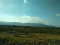 Landscape. Blue Sky with white clouds. The mountains in the distance. Desktop Royalty Free Stock Photo