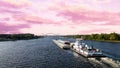 Landscape of boat in Mississippi River under a pink cloudy sky in La Crosse, Wisconsin