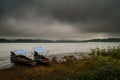 Landscape with boat and sea under the rain and cloudy sky in the Royalty Free Stock Photo