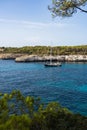 Landscape with boat and turquoise sea water on Cala Mondrago, Majorca island, Spain Royalty Free Stock Photo