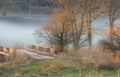 Landscape with a bridge over a river and fog