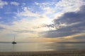 Landscape of bright sea and clouds with the golden rays of the sun come out from behind the clouds with silhouette of ship boat Royalty Free Stock Photo