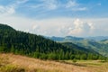 Landscape of bright summer day in Carpathian mountains, panorama of Carpathians, blue sky, trees and green hills, beautiful view