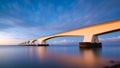 Landscape during a bright sundown. The sea and the bridge. Zeeland bridge, Netherlands Royalty Free Stock Photo