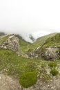 Landscape from Bucegi Mountains, part of Southern Carpathians in Romania in a foggy day Royalty Free Stock Photo