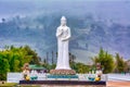 Landscape of the Buddha Statue of Avalokitesvara at Wat Pahuaylad on the background of foggy hill