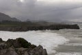 Landscape of Bufones de Pria in Asturias coast on a cloudy day with rough seas and wave spray Royalty Free Stock Photo