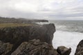 Landscape of Bufones de Pria in Asturias coast on a cloudy day with rough seas and wave spray Royalty Free Stock Photo