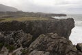 Landscape of Bufones de Pria in Asturias coast on a cloudy day with rough seas and wave spray Royalty Free Stock Photo