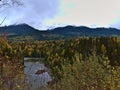 Landscape with Bulkley River in valley surrounded by trees in autumn with mountains in background north of Smithers, Canada. Royalty Free Stock Photo