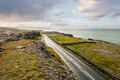 Landscape in Burren area by Atlantic ocean, West of Ireland. Small narrow asphalt road by the ocean, part of Wild Atlantic Way Royalty Free Stock Photo