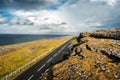 Landscape in Burren area by Atlantic ocean, West of Ireland. Small narrow asphalt road by the ocean, part of Wild Atlantic Way Royalty Free Stock Photo