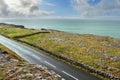 Landscape in Burren area by Atlantic ocean, West of Ireland. Small narrow asphalt road by the ocean, part of Wild Atlantic Way Royalty Free Stock Photo