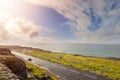 Landscape in Burren area by Atlantic ocean, West of Ireland. Small narrow asphalt road by the ocean, part of Wild Atlantic Way Royalty Free Stock Photo