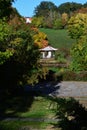 Landscape with chinese pagoda standing next to arboretum pond, surrounded by colorful autumn trees Royalty Free Stock Photo