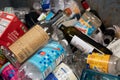 A landscape closeup view of inside of an apartment building`s recycling bin containing glass and plastics