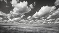 landscape with clouds on large flat field or beach next to the ocean