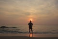 Landscape of cloudy sky and sea that has fisherman who hold fishnet stand on the beach in morning Royalty Free Stock Photo