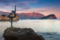 Landscape of coast: Budva old town, the Dancing Girl Statue,Sveti Nikola island and mountains at sunset . Montenegro.