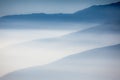 Landscape with colorful layers of mountains and haze in the valleys. Ideal as natural background.