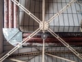 Landscape colour image of old derelict industrial factory roof ceiling with steel heating pipes for old air conditioning and metal Royalty Free Stock Photo