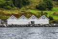 The landscape of cottages on a rock among the greenery off the coast of Norway. Royalty Free Stock Photo