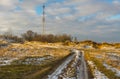 Landscape with country road leading to cellular radio tower in Ukrainian rural area Royalty Free Stock Photo