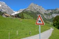 Landscape with cow roadsign at Engelberg in the Swiss alps Royalty Free Stock Photo