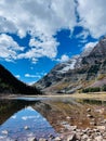 Landscape of Crater Lake Trail at Maroon Bells mountains with blue cloudy sky, vertical shot Royalty Free Stock Photo