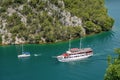 Landscape of a cruise ship on the river surrounded by greenery in Skradin, Croatia