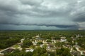 Landscape of dark ominous clouds forming on stormy sky before heavy thunderstorm over rural town area Royalty Free Stock Photo