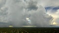 Landscape of dark ominous clouds forming on stormy sky during heavy thunderstorm over rural town area Royalty Free Stock Photo