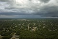 Landscape of dark ominous clouds forming on stormy sky before heavy thunderstorm over rural town area Royalty Free Stock Photo