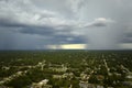 Landscape of dark ominous clouds forming on stormy sky during heavy thunderstorm over rural town area Royalty Free Stock Photo