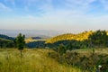 Landscape in dehradun with grassy fields, mountains and blue ski