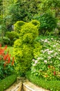 Landscape design - green figure of bear between flowers Royalty Free Stock Photo