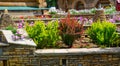 Landscape design of home garden, landscaping with stone retaining walls and flowerbeds