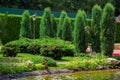 Landscape design of a park on the lake with a stone shore. Royalty Free Stock Photo