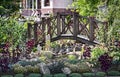 A small wooden bridge over the pond. Royalty Free Stock Photo