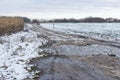 Landscape with dirty road leading to small village in Sumskaya oblast, Ukraine Royalty Free Stock Photo