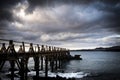 Landscape of a dock of wood on the sea in a rocky and beautiful place - nobody at the place and bad weather - Lanzarote, Canary Royalty Free Stock Photo